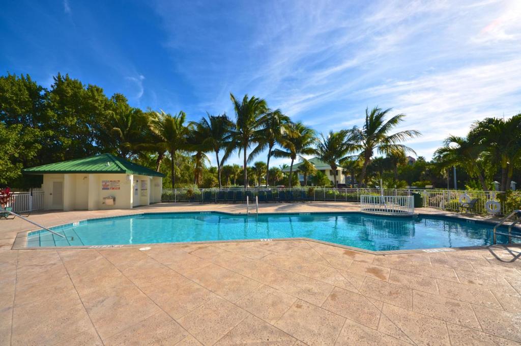 基韦斯特Sunrise Suites Big Kahuna Suite #202的一座棕榈树环绕的大型游泳池