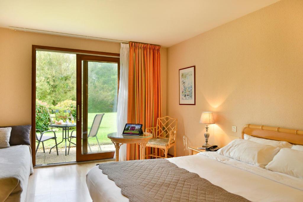 卢瓦尔河畔普伊普宜瑞莱之家酒店的一间卧室配有一张床,阳台配有桌子