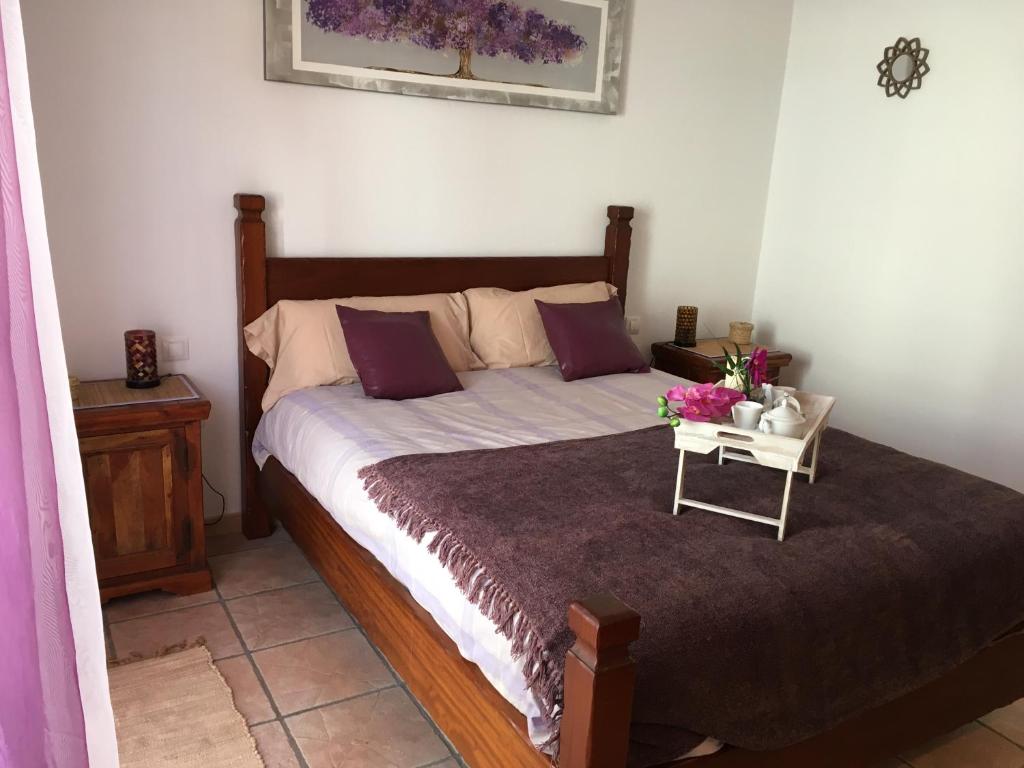 阿雷西费Casa Daniela的一间卧室配有一张带鲜花桌的床