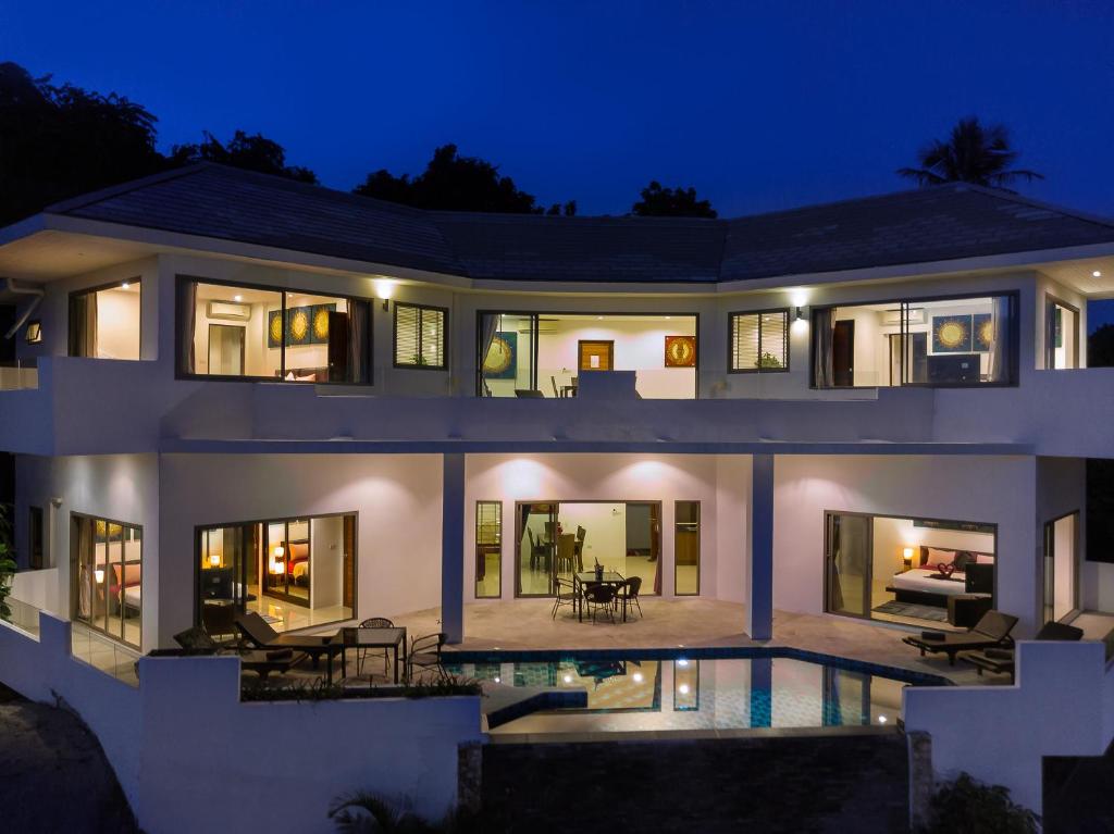拉迈Villa Sea View的一座白色的大房子,晚上设有游泳池