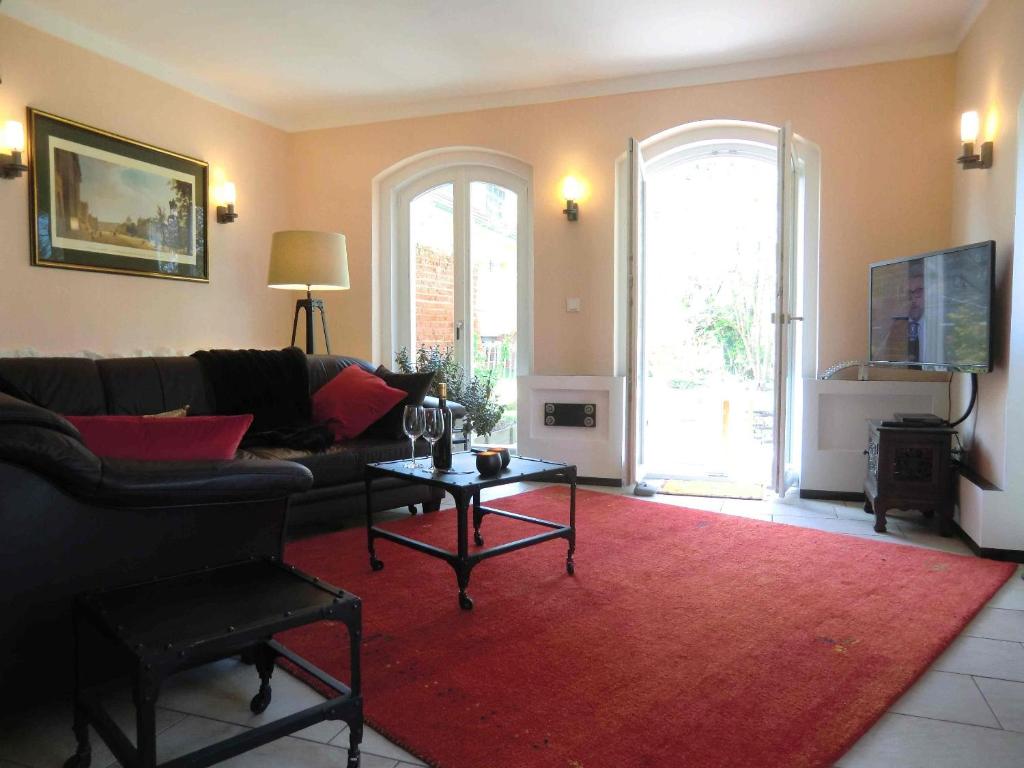 泰尔托maisonette的带沙发和红色地毯的客厅