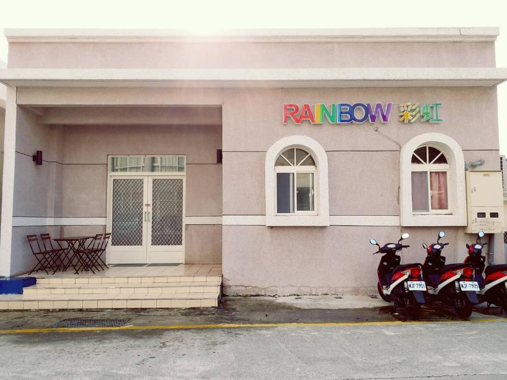 绿岛绿岛彩虹民宿-Rainbow的停在大楼前的两辆摩托车