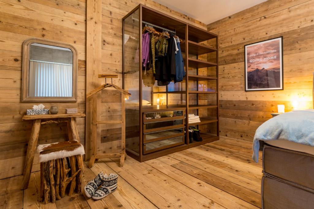 菲施WOO® Loft Resort的一间卧室设有木墙、一张床和一个衣柜