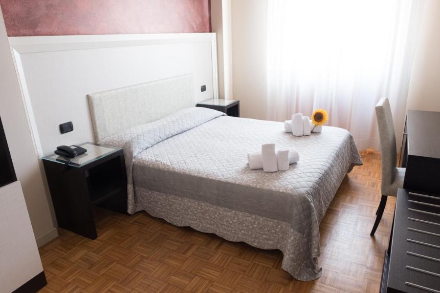 菲登扎阿索托丽亚酒店的一间卧室配有一张带两张蜡烛的床。