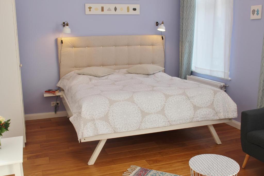 不莱梅Apartment Flieder Zentral的一间卧室配有一张带白色床罩的大床