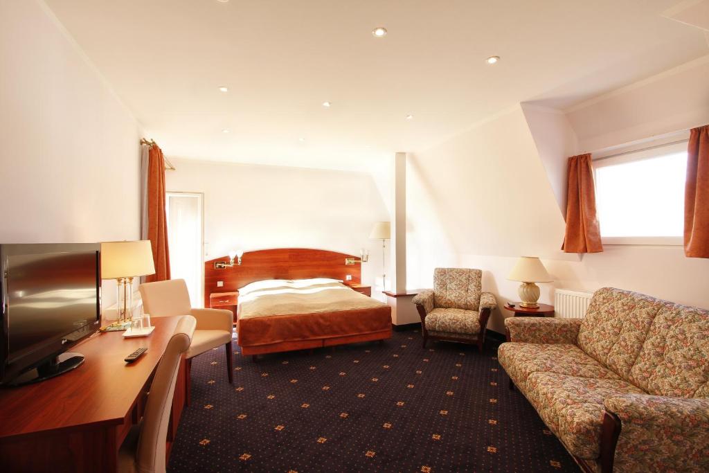 汉堡普罗伊斯达姆图帕莱斯酒店的酒店客房,配有床和沙发