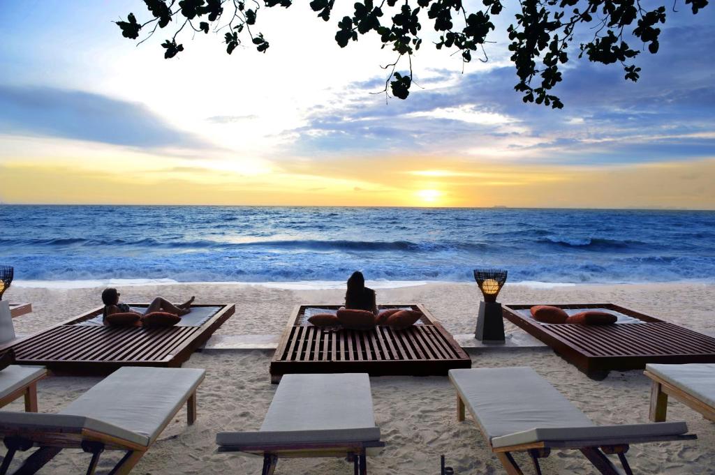 高兰兰塔沙洲Spa度假酒店的一群人躺在海滩上的野餐桌上