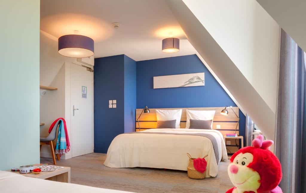 卡马雷Village Vacances de Pen-Hir的一间拥有蓝色墙壁的卧室和一张饲养着动物的床