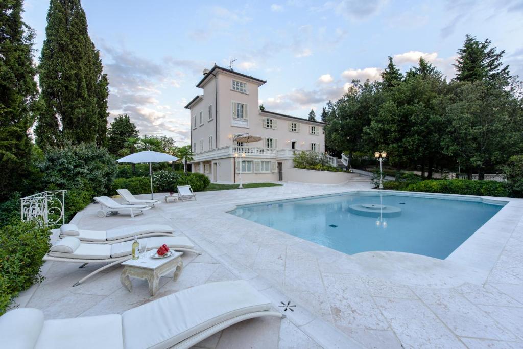 蒙泰斯佩尔托利Villa Rinaldi的房屋前有游泳池的房子