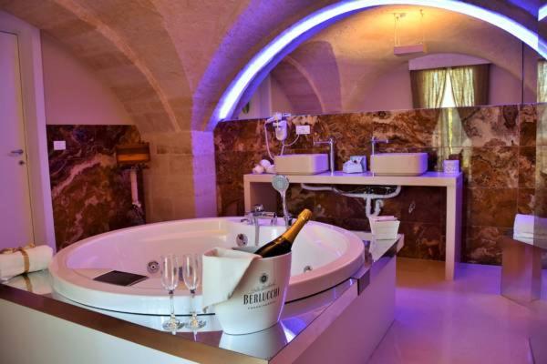 格拉维纳普利亚B&B Sul Ponte的带浴缸和一瓶香槟的大浴室