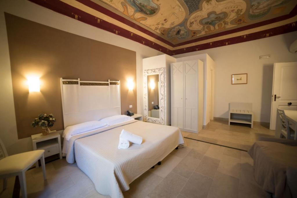 锡拉库扎加加略酒店的一间卧室设有两张床和天花板