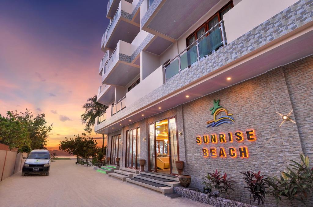 马富施日出海滩公寓式酒店的一座带有读取日出海滩标志的建筑