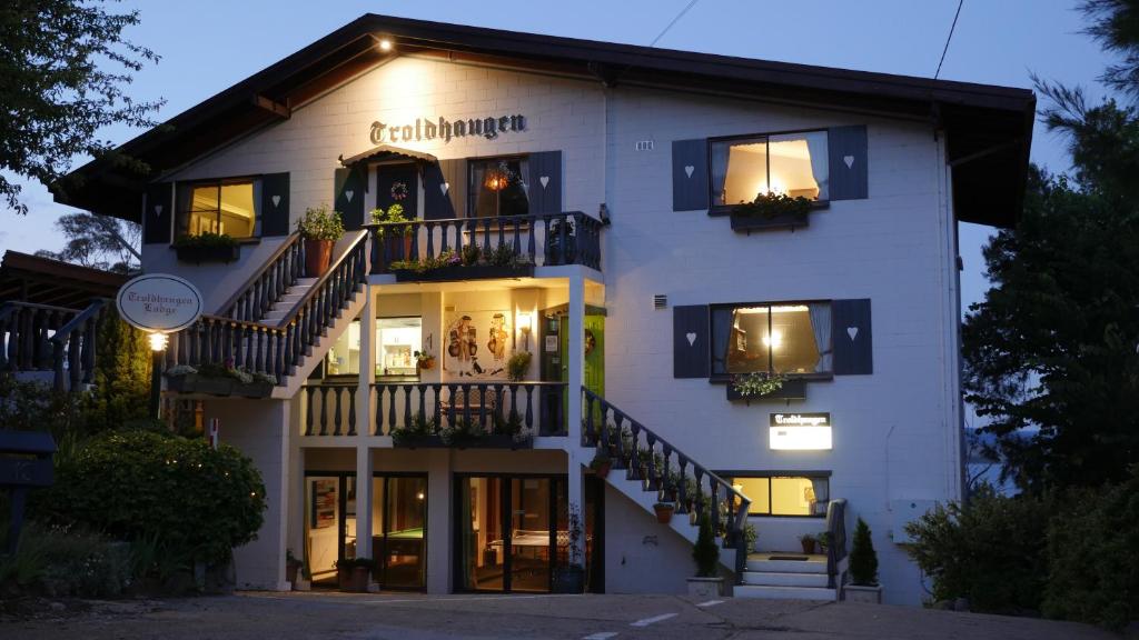 金德拜恩Troldhaugen Lodge - Adults Only的前面有楼梯的大型白色建筑