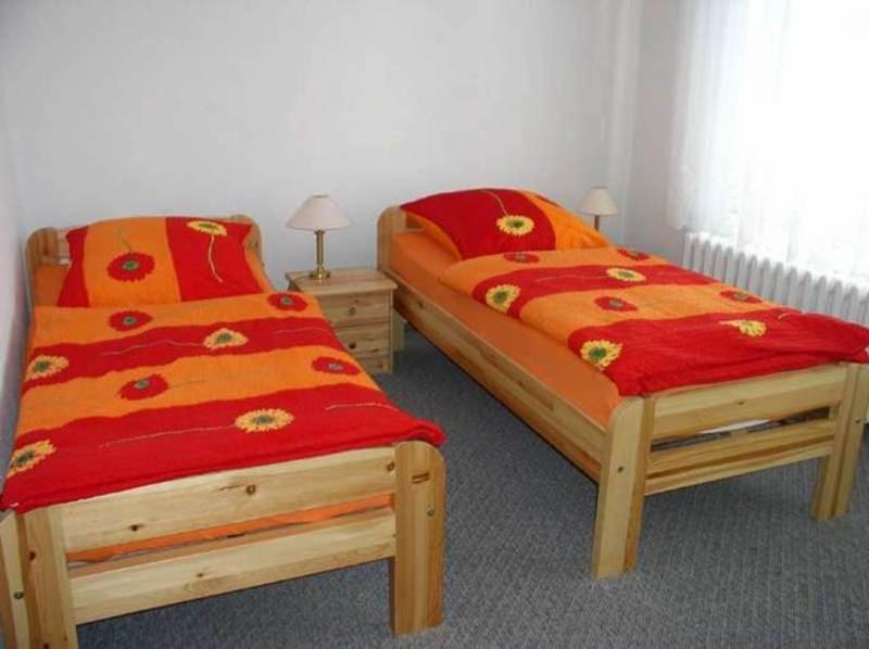 巴特多布兰Ferienwohnung Bad Doberan MOST 2081的两张红色和橙色床罩
