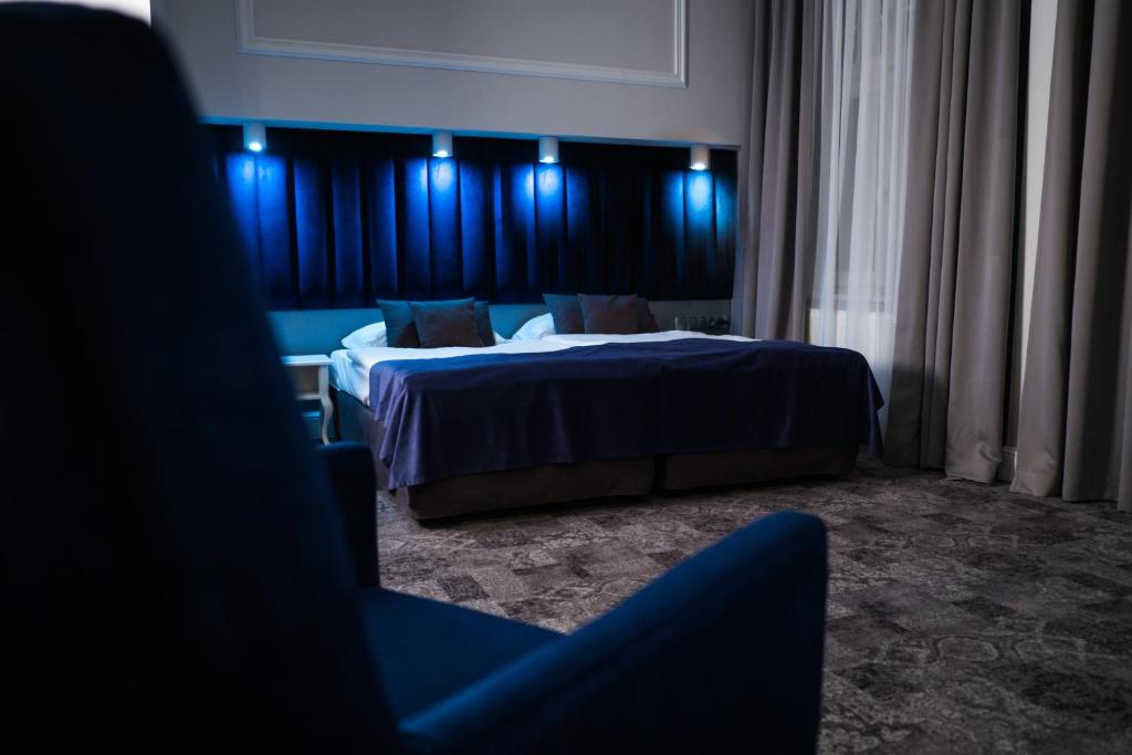绿山城City Boutique Hotel的酒店客房带两张床和蓝色灯光