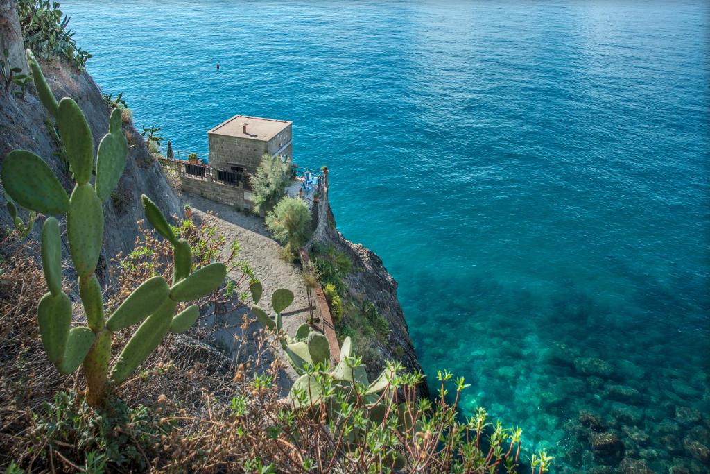 蒙特罗索阿尔马雷德尔多甘尼耶度假屋的水边悬崖上的房屋