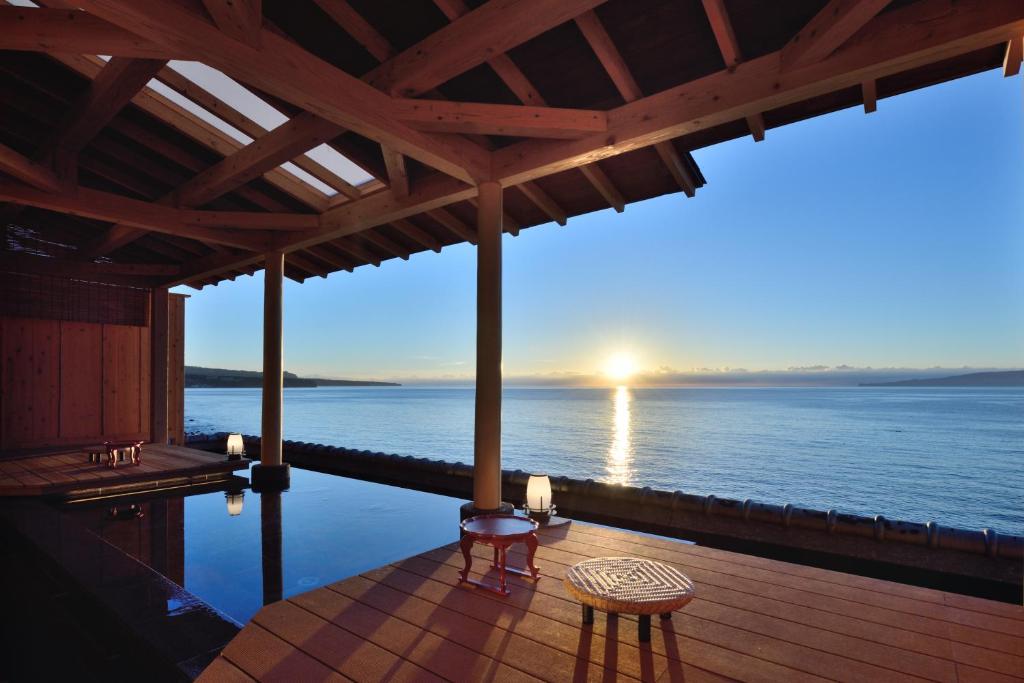 东伊豆町包穗日式旅馆的甲板上配有桌椅,享有海景。
