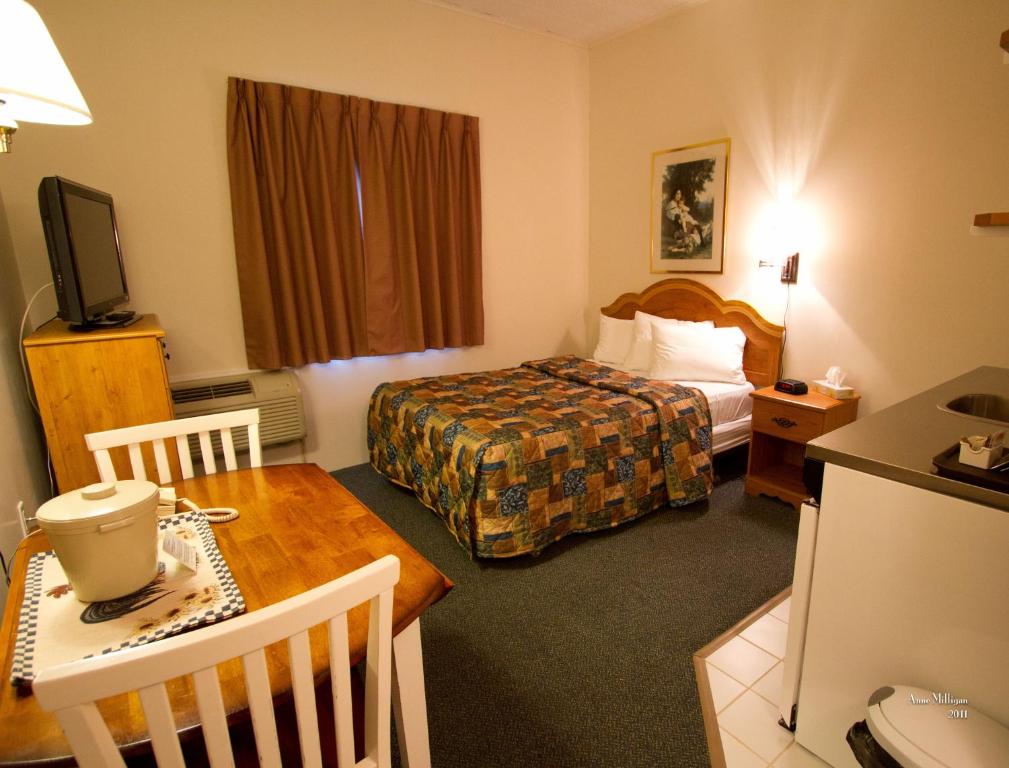 钱纳尔-巴斯克港巴斯克港口酒店的酒店客房配有一张床铺和一张桌子。
