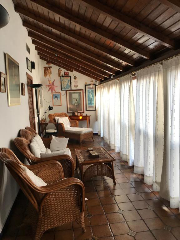 科尔多瓦Casa longa的客厅设有藤椅、桌子和窗户