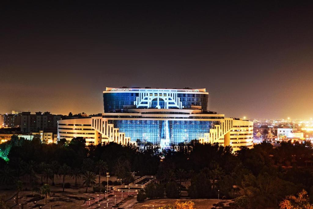 多哈多哈城市中心假日别墅酒店&公寓的一座晚上有蓝色灯光的建筑