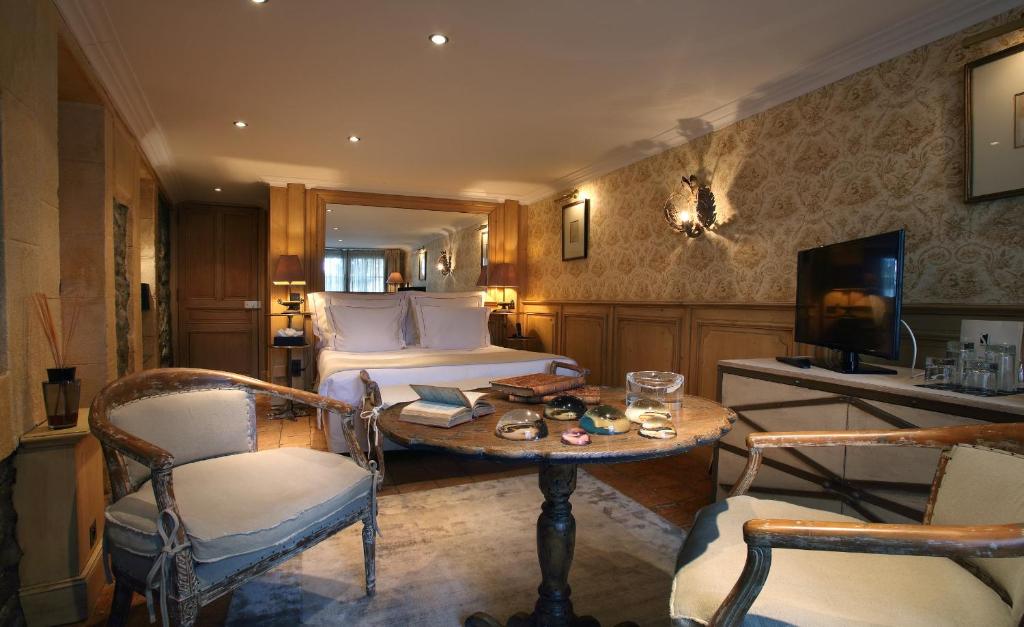 谷雪维尔圣约瑟夫酒店的酒店客房带一张床、一张桌子和椅子