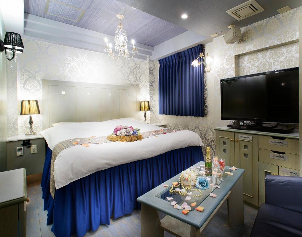 大阪ホテル リトルチャペルクリスマス 梅田的一间带大床和电视的卧室