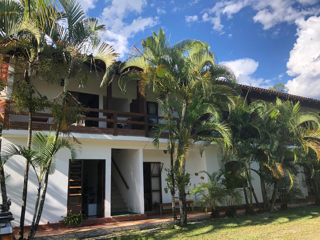 博西坎加Pousada Farol do Marinheiro的前面有棕榈树的房子