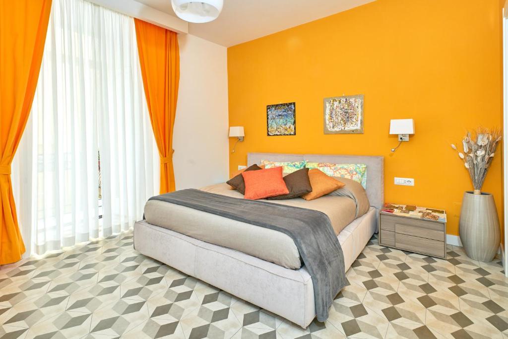 那不勒斯A Casa del Principe LT的一间卧室配有一张橙色墙壁的床