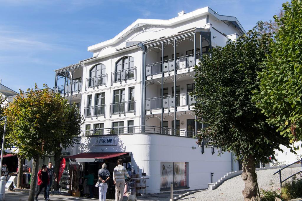奥斯赛拜-塞林Villa Louisa - Wohnung 51的一座白色的建筑,前面的人站在
