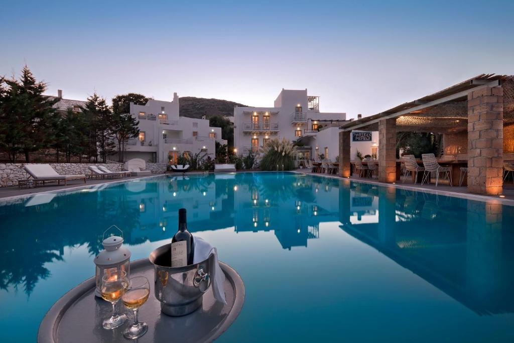 斯基罗斯岛内菲利酒店的游泳池,提供一瓶葡萄酒和玻璃杯