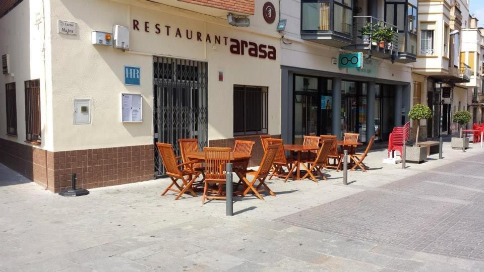 圣巴巴拉阿拉撒酒店餐厅的一组木桌和椅子,在餐厅外