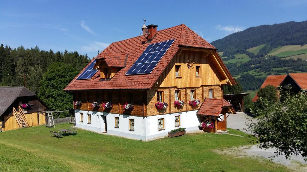 穆劳附近圣洛伦岑Pension - Bauernhof的屋顶上设有太阳能电池板的房子