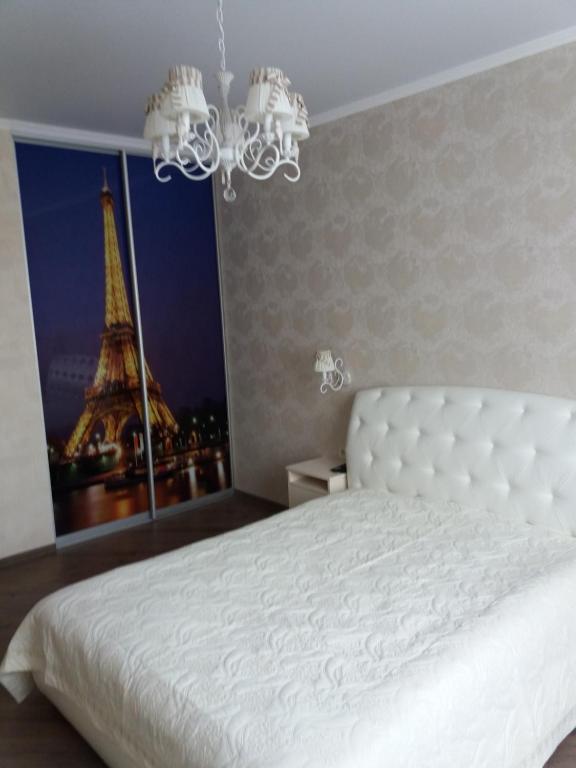 敖德萨Альтаир2的一间带白色床的卧室和艾菲尔铁塔