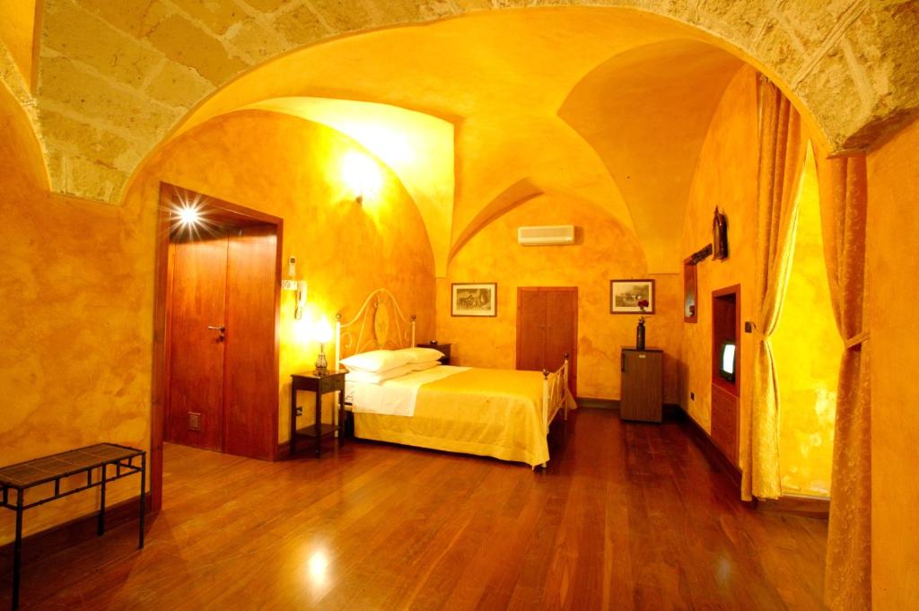加拉蒂纳内尔特罗斯托里科酒店的大房间中一间带床的卧室