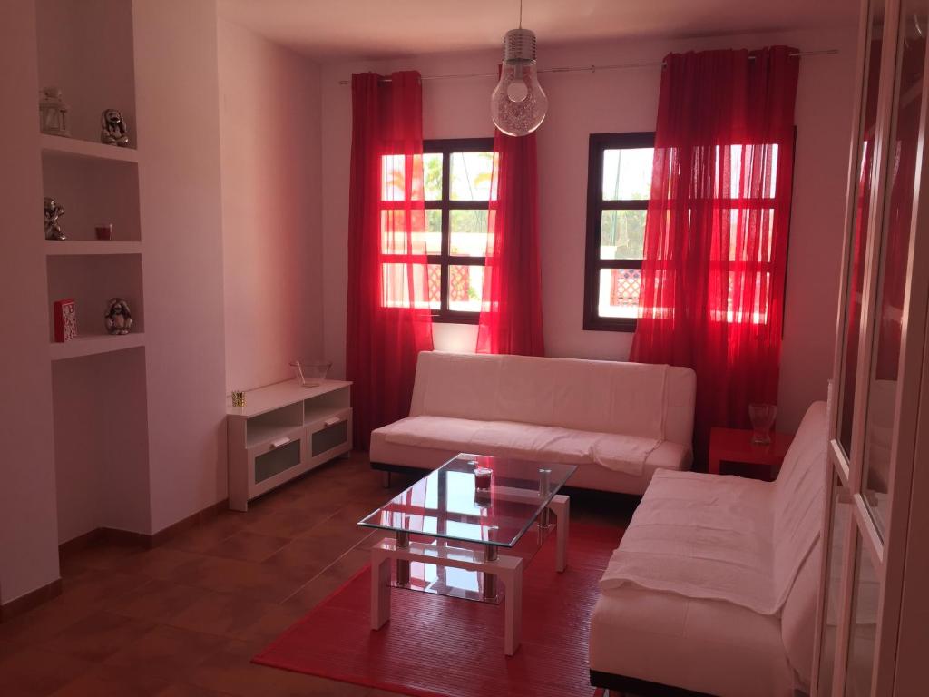 莫特里尔Playa Granada Golf的客厅配有红色窗帘和白色沙发