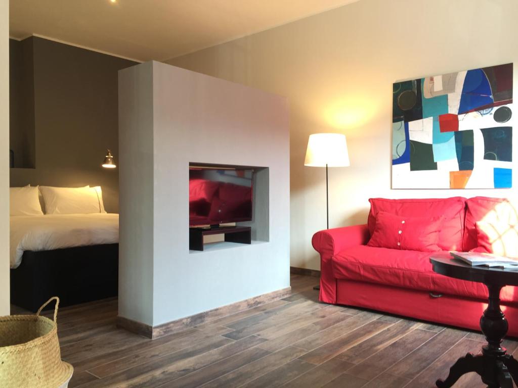 博洛尼亚charming new loft的客厅配有红色的沙发和床。