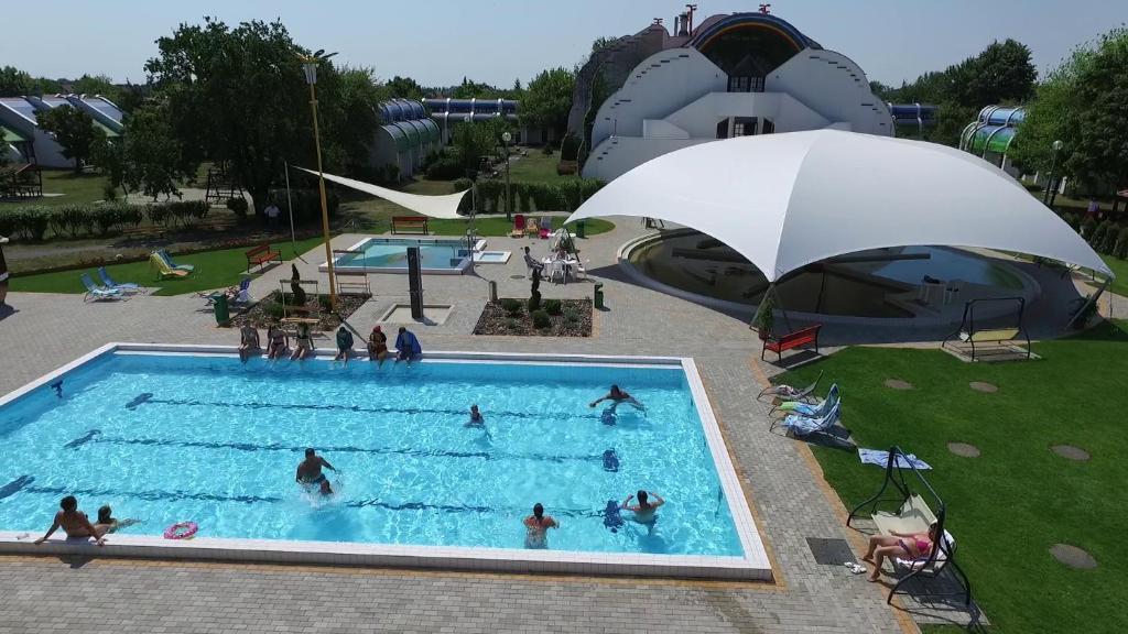 久洛赫福乐思酒店的一群人在带遮阳伞的游泳池里