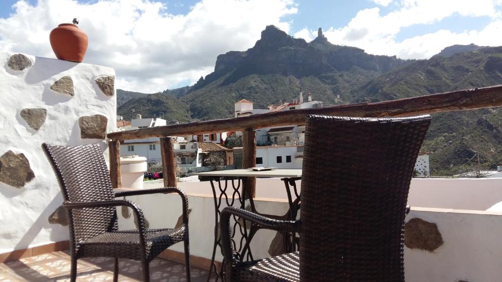 克鲁兹·德·特赫达Casa Canaria Tejeda的山景阳台上配有两把椅子和一张桌子