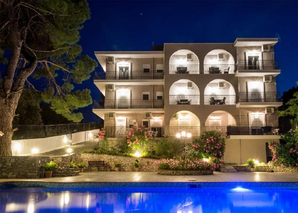 克里奥斯Villa Albanis的一座建筑,在晚上前方有一个游泳池