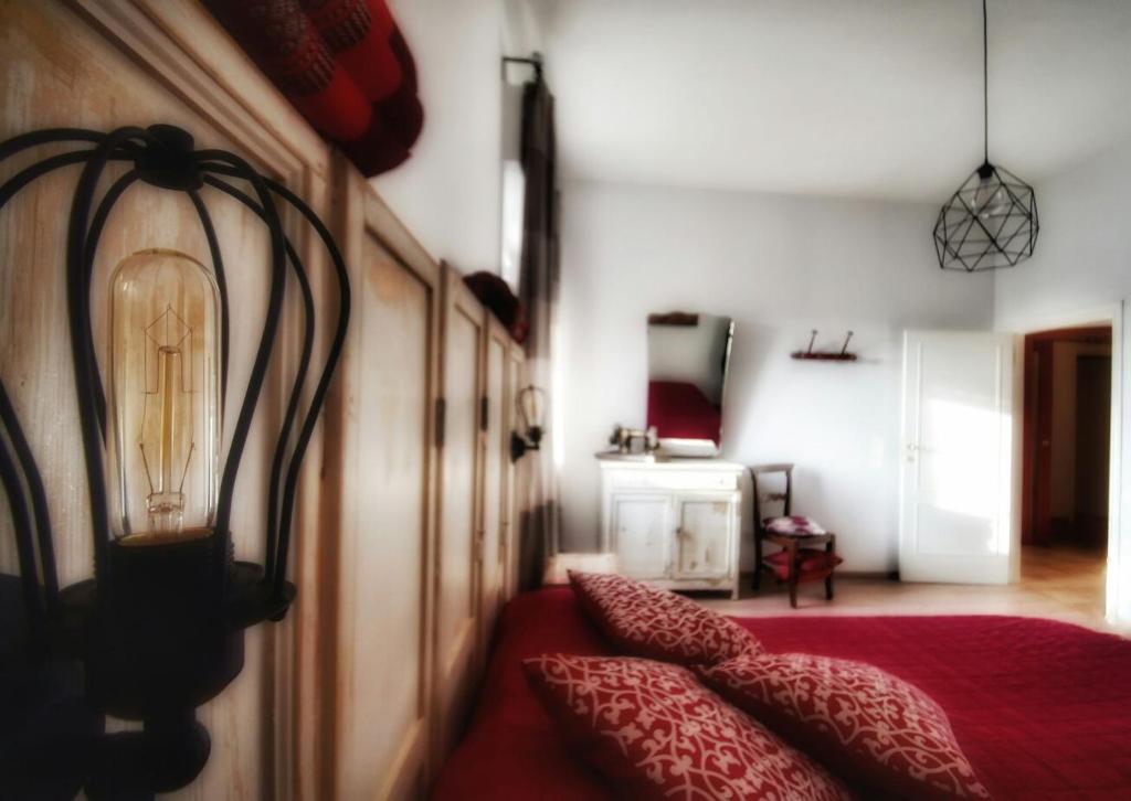 MontecarottoB&B Teranga的一间卧室配有红色的床,上面有灯