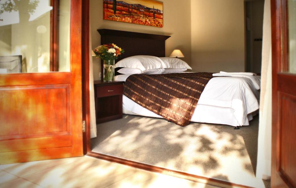 金伯利Mondior Manor Guest House的一间卧室配有带白色枕头的床
