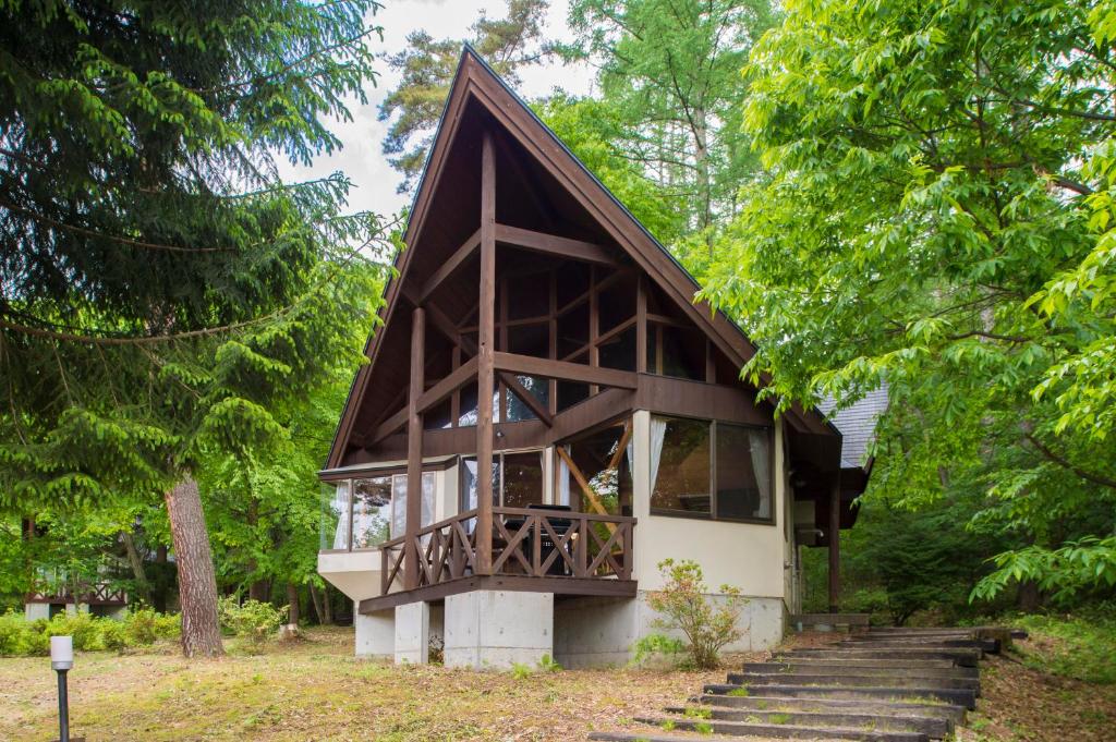 安昙野市Izumigo AMBIENT Azumino Cottage的一座带木屋顶的小房子