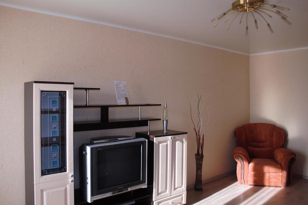 Leninsk-KuznetskiyОднокомнатная квартира的客厅配有电视和椅子