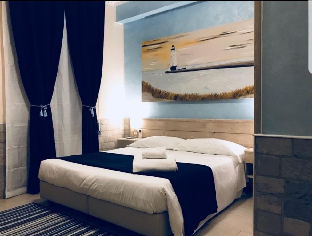 菲乌米奇诺夫米希诺机场豪华酒店 的一间卧室配有一张带灯塔画的床铺