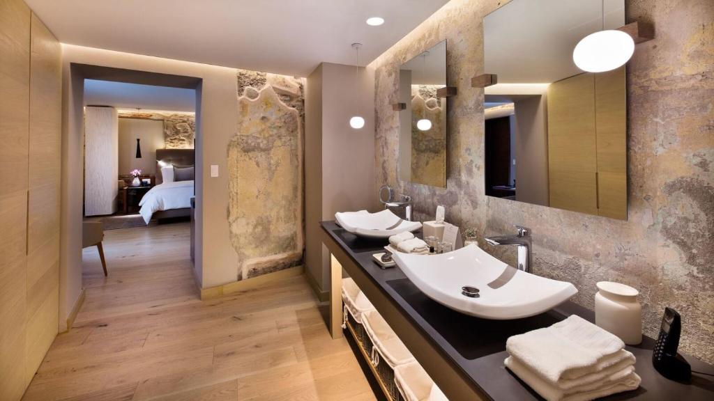 普埃布拉Cartesiano Boutique & Wellness Hotel的一间带两个盥洗盆和大镜子的浴室