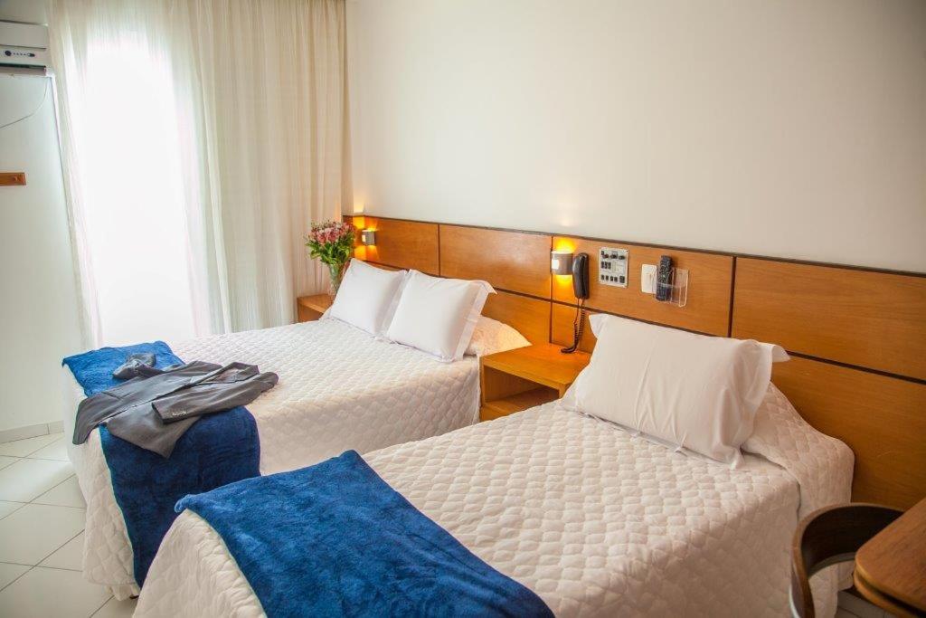 桑托斯大西洋公寓酒店的酒店客房设有两张床和窗户。