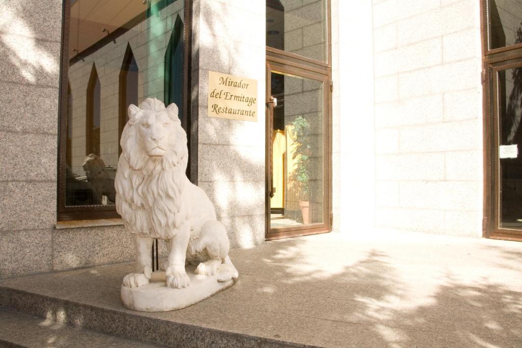 拉瓦涅萨艾米塔基米拉多酒店的狮子雕像坐在建筑物前