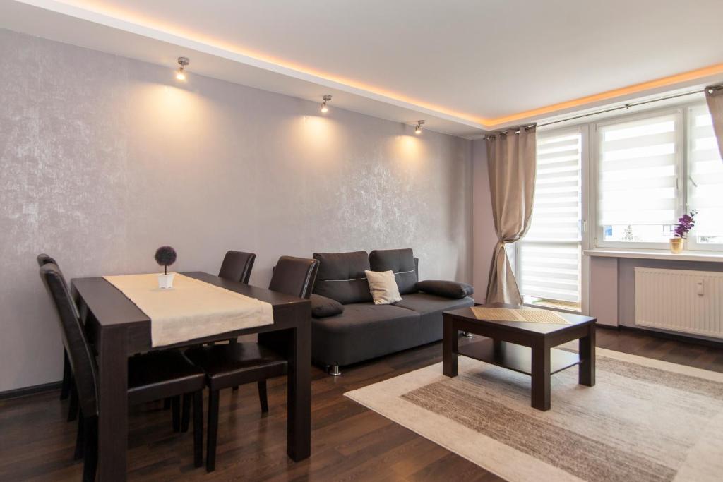 比亚韦斯托克Pałacowa Condominium的客厅配有沙发和桌子
