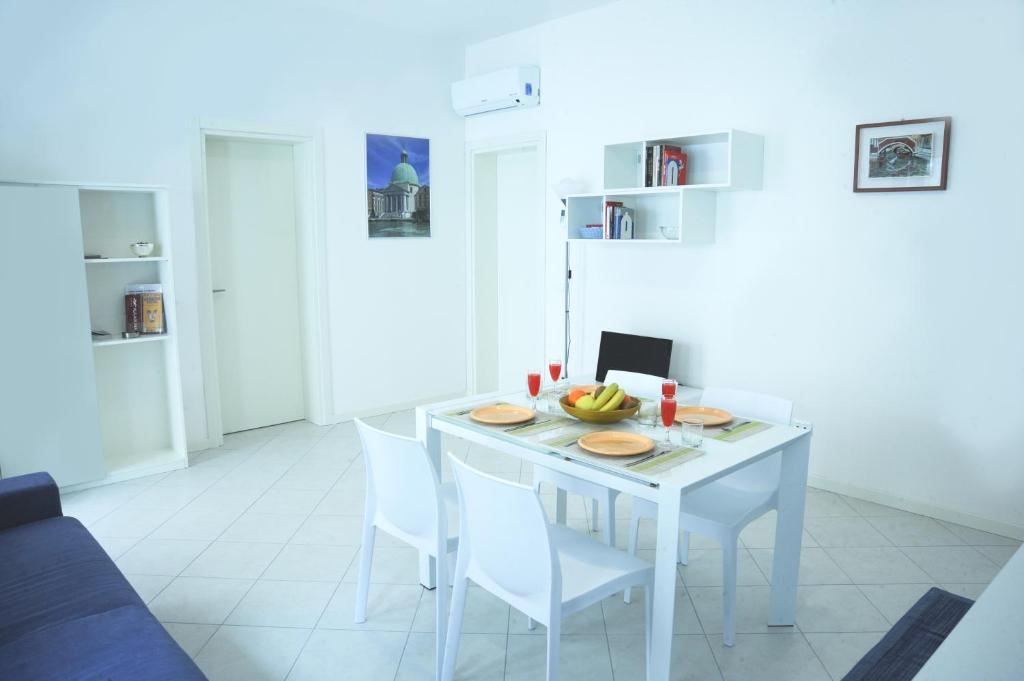 威尼斯Residenza Ca' Matta的厨房配有白色的桌子和白色的椅子
