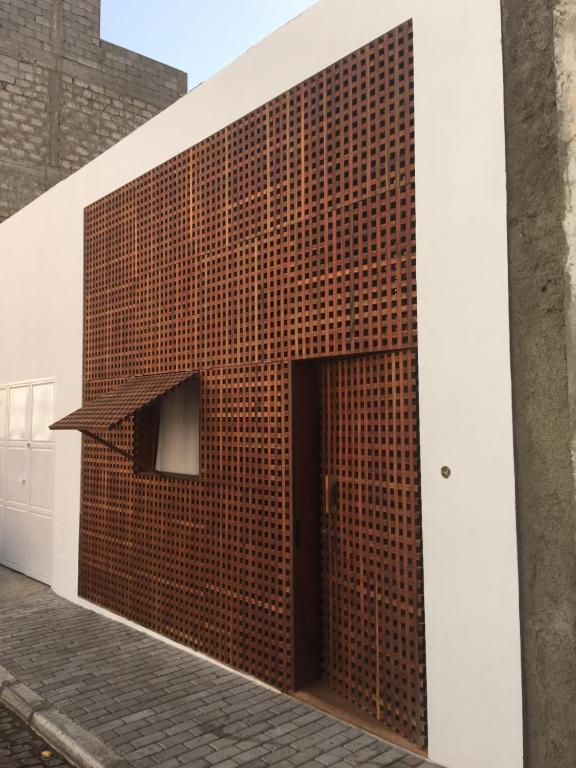 明德卢Studio M的大楼上一堵砖墙,有一扇门